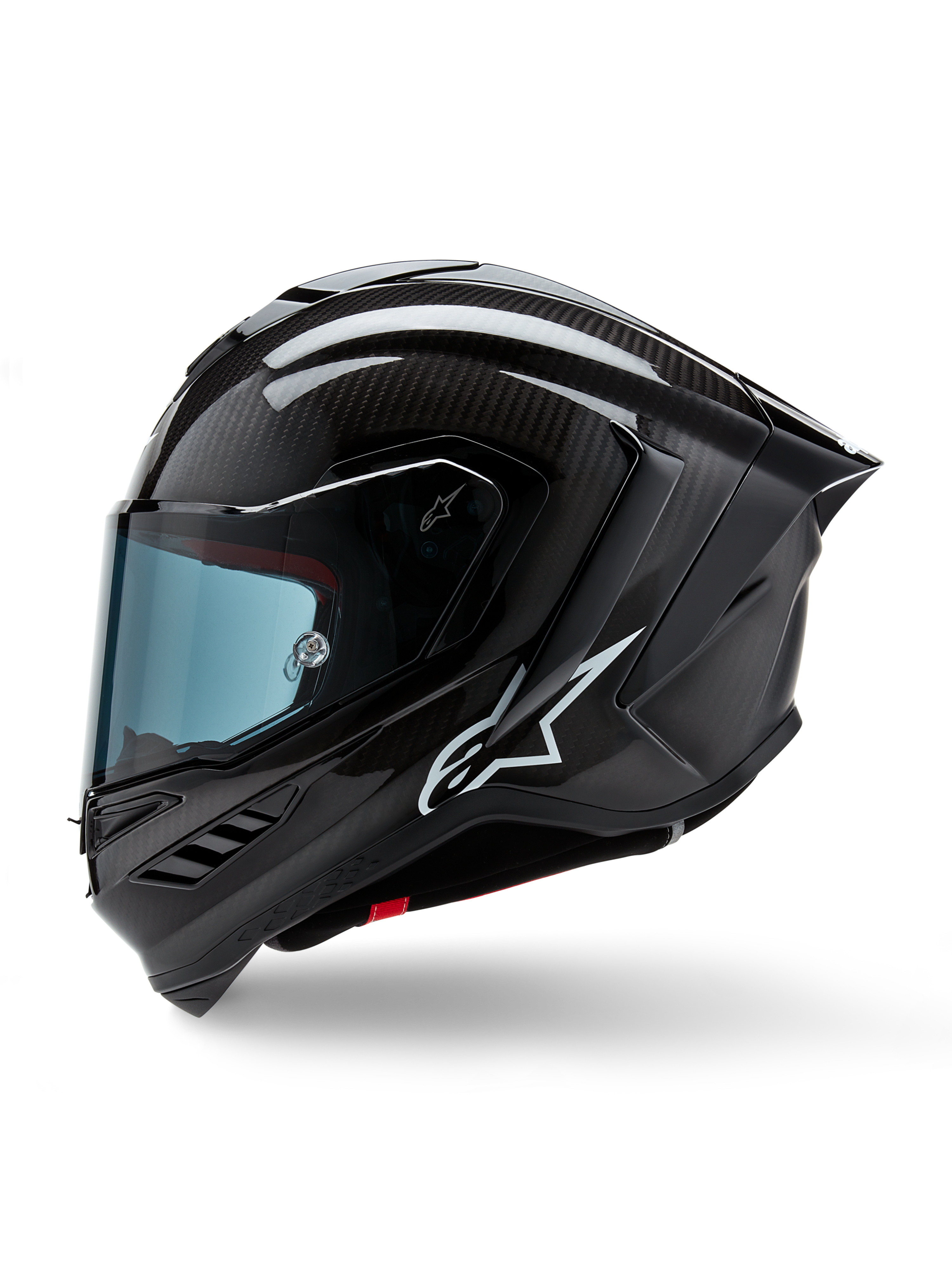 Casco Alpinestars Supertech R10 Solid, casco integrale racing da moto, carbonio nero opaco e lucido, trama in fibra di carbonio a vista, logo Alpinestars bianco sul lato, design aerodinamico con spoiler posteriore integrato e prese d'aria, vista laterale di profilo