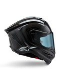 Casco Alpinestars Supertech R10 Solid, carbonio nero opaco e lucido, casco da moto racing, costruzione in fibra di carbonio, profilo laterale, visiera blu, design aerodinamico con alette, logo bianco, protezione ad alte prestazioni di livello MotoGP