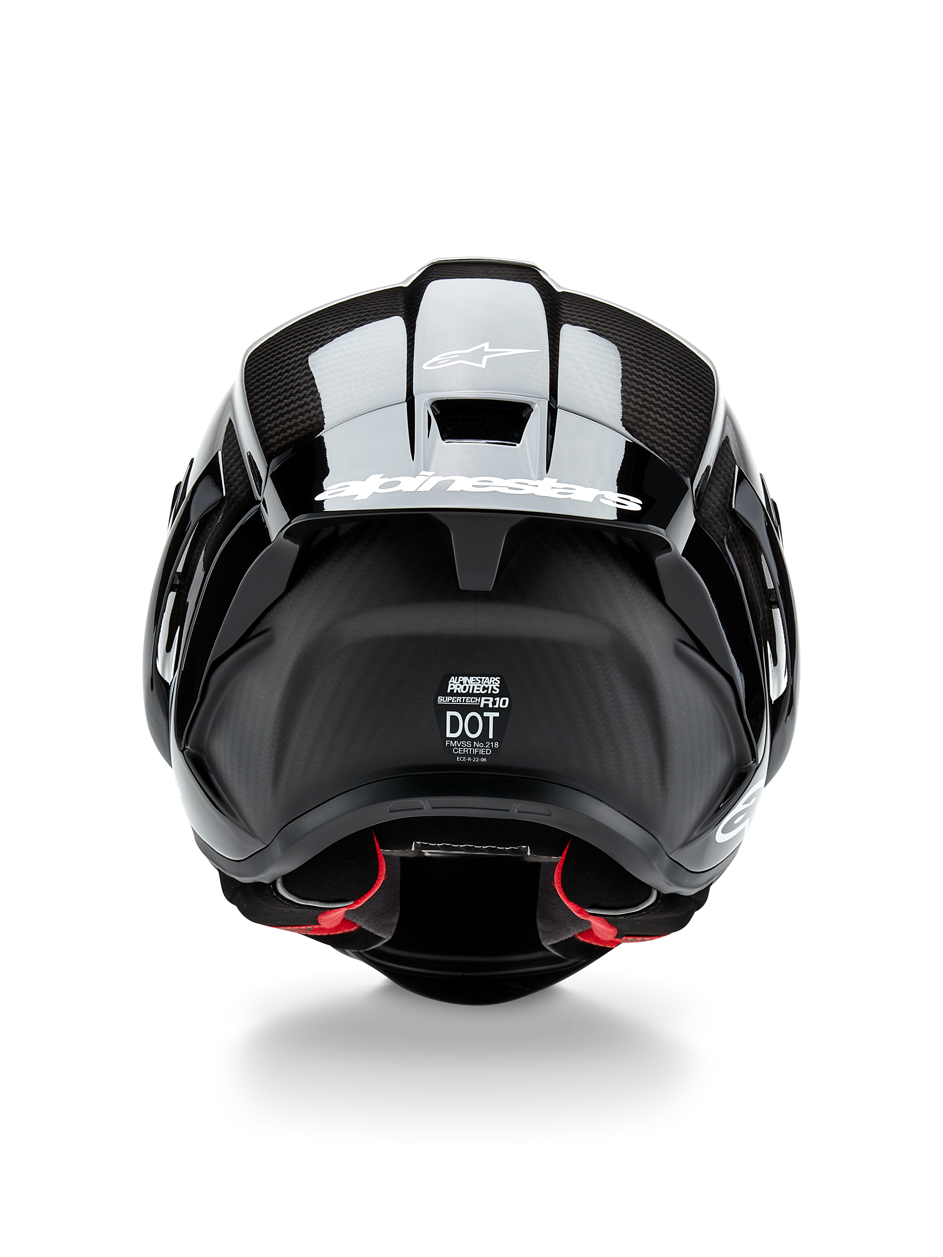 Casco Alpinestars Supertech R10 Solid, casco da moto, carbonio nero opaco e lucido, vista posteriore con trama in fibra di carbonio, spoiler aerodinamico con logo Alpinestars bianco, etichette di certificazione di sicurezza DOT ed ECE e imbottitura interna rossa