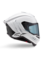 Casco Alpinestars Supertech R10 Solid, casco da moto racing bianco lucido e nero opaco, vista laterale di profilo, design aerodinamico con alette posteriori e prese d'aria laterali, visiera con tinta blu, caratterizzato dal logo a stella Alpinestars nero sul lato