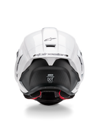 Casco Alpinestars Supertech R10 Solid, vista posteriore, parte superiore bianca lucida con sezione inferiore nera opaca, spoiler aerodinamico con logo Alpinestars nero, trama in fibra di carbonio a vista e decalcomanie delle certificazioni di sicurezza