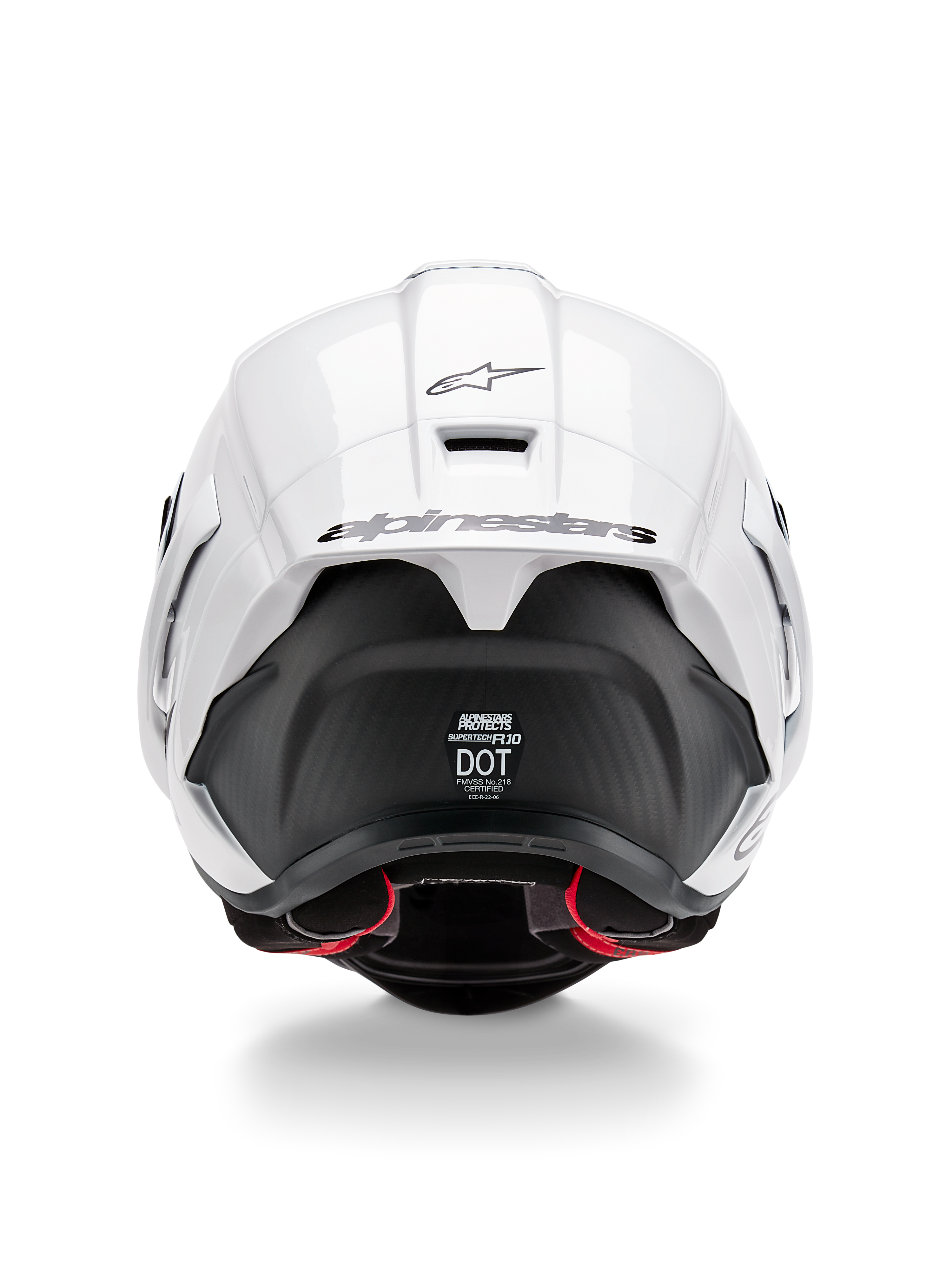 Casco Alpinestars Supertech R10 Solid, vista posteriore, parte superiore bianca lucida con sezione inferiore nera opaca, spoiler aerodinamico con logo Alpinestars nero, trama in fibra di carbonio a vista e decalcomanie delle certificazioni di sicurezza