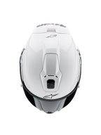 Casco Alpinestars Supertech R10 Solid, casco da moto integrale, bianco lucido, vista dall'alto che mette in evidenza le prese d'aria aerodinamiche e i loghi Alpinestars neri, profilo aerodinamico ispirato alle corse.