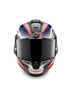 Casco Alpinestars Supertech R10 Team, casco integrale da moto racing, carbonio nero con grafiche blu opaco e rosso fluo, vista frontale con visiera fumé scura, design aerodinamico con prese d'aria integrate, equipaggiamento racing ad alte prestazioni