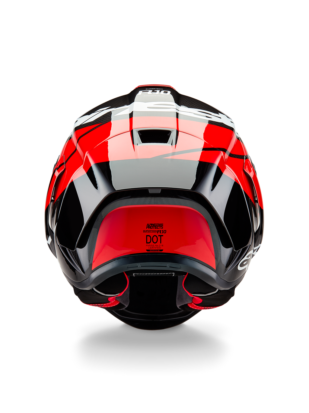 Casco Alpinestars Supertech R10 Element, vista posteriore, nero carbonio con accenti rosso brillante e bianco lucido, con spoiler posteriore aerodinamico, prese d'aria di scarico ed etichetta di certificazione DOT, design elegante di ispirazione racing con dettagli in fibra di carbonio