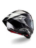 Casco Alpinestars Supertech R10 Element, Nero Carbonio Argento Nero Lucido, vista posteriore a tre quarti che mostra il profilo aerodinamico da corsa, calotta in fibra di carbonio lucida con grafiche geometriche grigie e nere, logo Alpinestars e imbottitura interna rossa