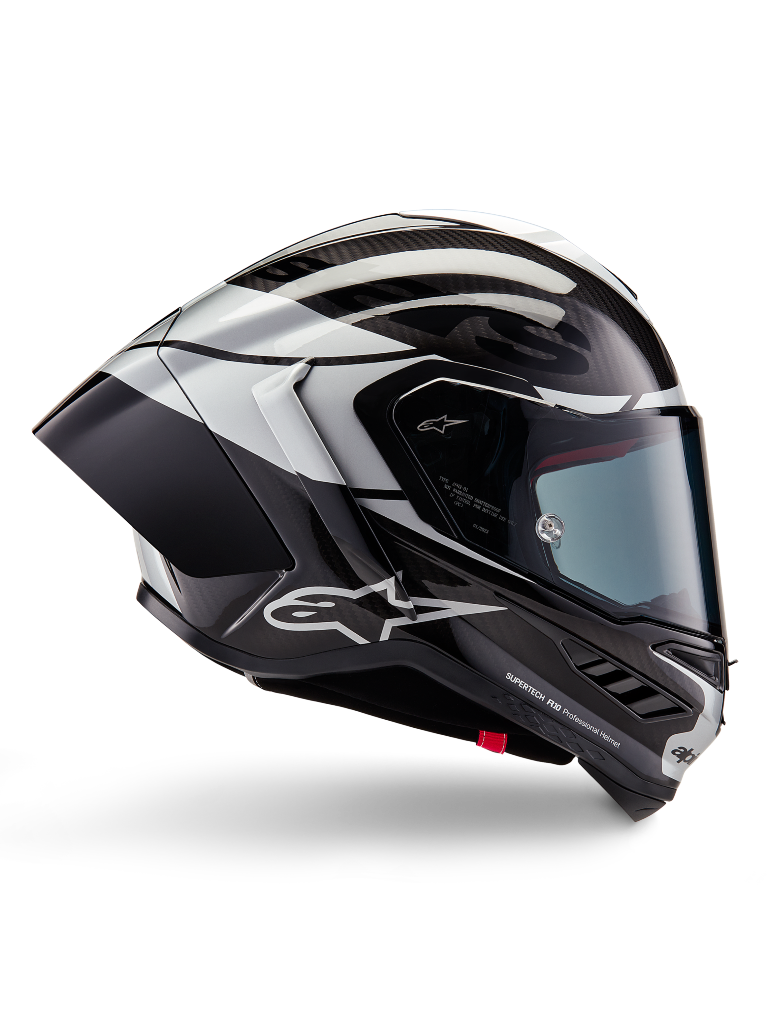 Casco Alpinestars Supertech R10 Element, casco moto integrale racing, finitura in carbonio nero, argento e nero lucido, vista laterale con calotta aerodinamica in fibra di carbonio, visiera trasparente e logo Alpinestars evidente