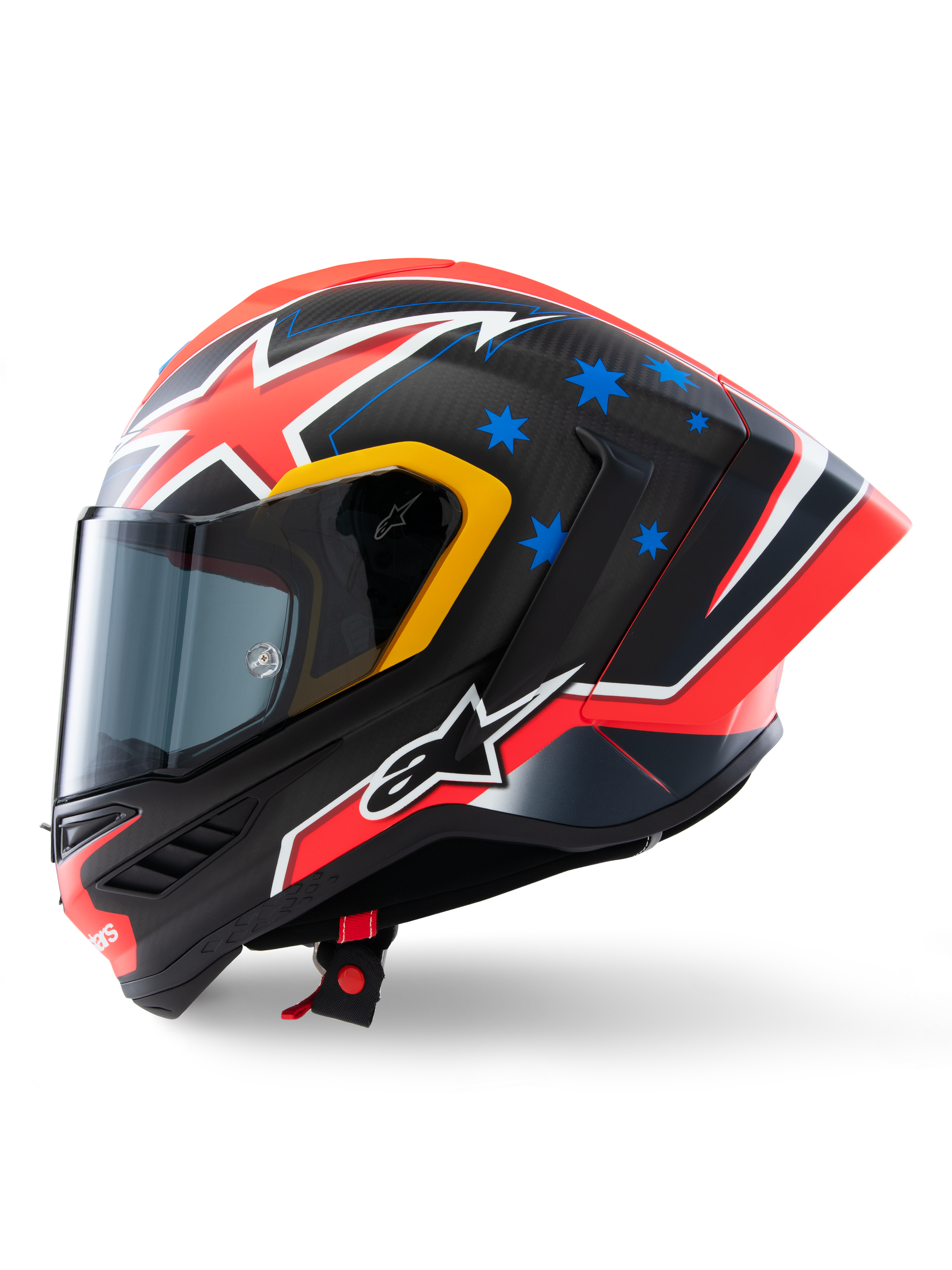 Casco Alpinestars Supertech R10 Miller Limited Edition, profilo laterale, finitura Carbon Red Matt con fibra di carbonio a vista, grafiche a fulmine rosse e bianche, stelle blu sul retro, dettagli gialli sulla visiera e logo Alpinestars bianco, casco da moto da corsa ad alte prestazioni