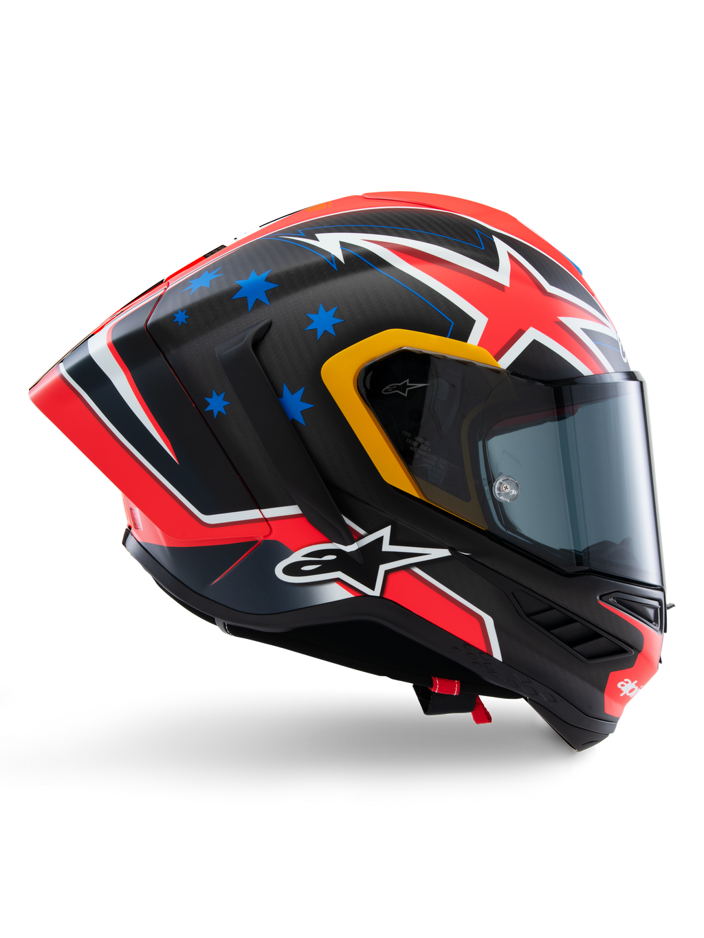 Casco Alpinestars Supertech R10 Miller Limited Edition, casco integrale racing, carbonio opaco con grafica rossa, bianca e blu, dettagli con stelle blu e rifiniture gialle della visiera, profilo aerodinamico con visiera scura fumé, equipaggiamento di sicurezza per moto ad alte prestazioni