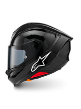 Casco Alpinestars S-R7 Solid, casco integrale da moto, nero lucido, vista laterale sinistra con logo Alpinestars bianco, calotta aerodinamica con spoiler integrato, visiera oscurata e dettagli rossi per il rilascio d'emergenza