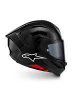 Casco Alpinestars S-R7 Solid, casco integrale da moto, nero lucido, vista laterale con logo Alpinestars bianco, calotta aerodinamica con spoiler integrato e accenti rossi alla base, progettato per prestazioni racing e sportive.