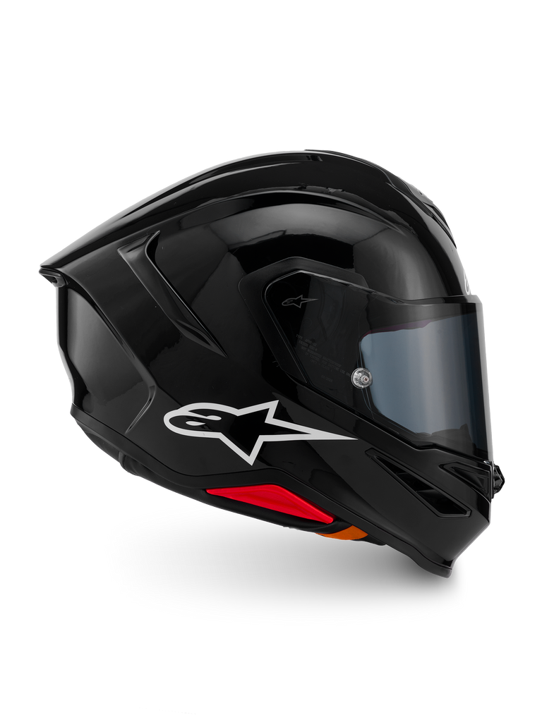 Casco Alpinestars S-R7 Solid, casco integrale da moto, nero lucido, vista laterale con logo Alpinestars bianco, calotta aerodinamica con spoiler integrato e accenti rossi alla base, progettato per prestazioni racing e sportive.