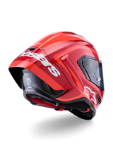 Casco Alpinestars Supertech R10 Arius, rosso lucido con loghi bianchi, vista posteriore a tre quarti che mostra lo spoiler aerodinamico, calotta in fibra di carbonio e profilo racing con visiera scura