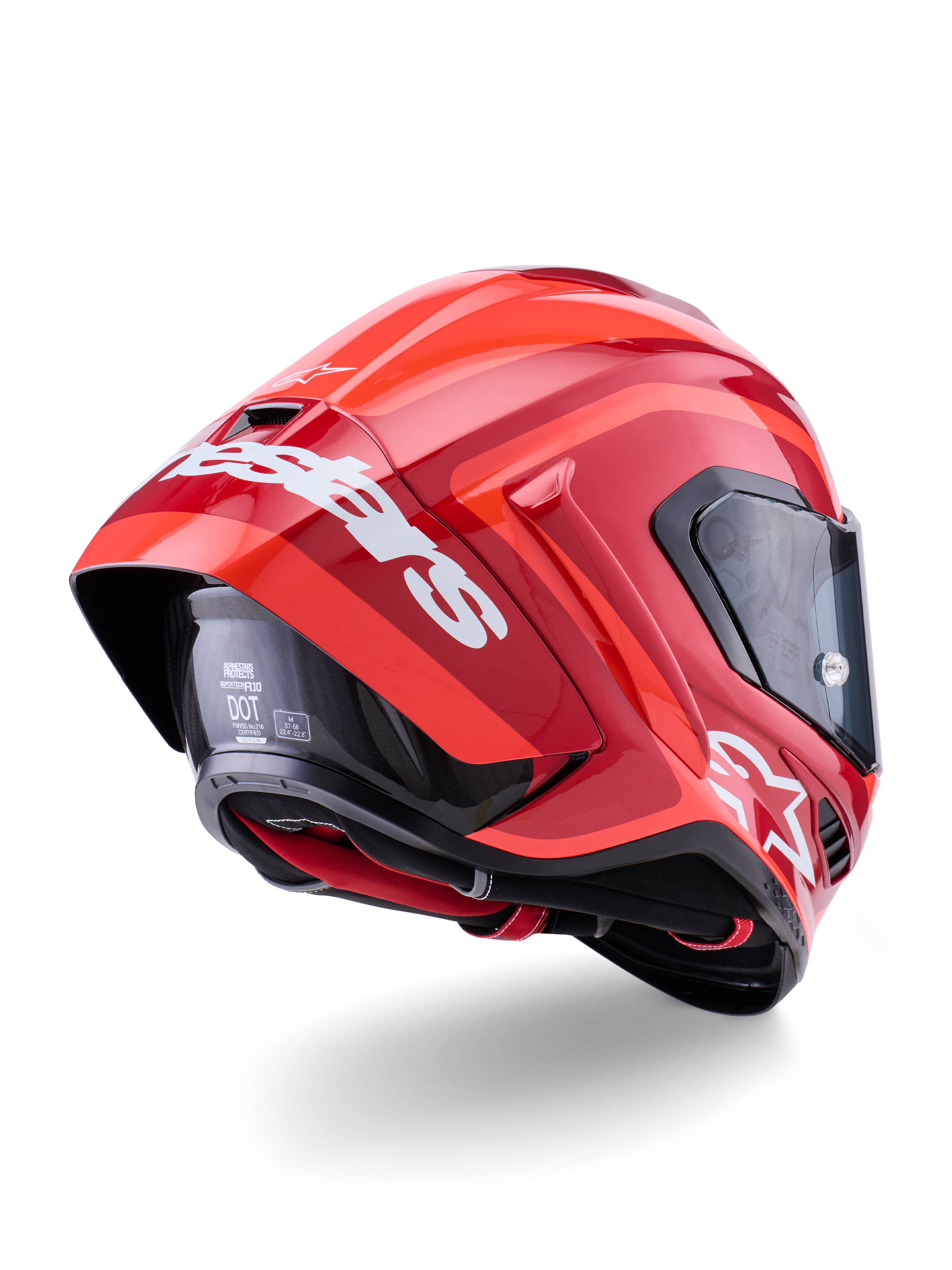 Casco Alpinestars Supertech R10 Arius, rosso lucido con loghi bianchi, vista posteriore a tre quarti che mostra lo spoiler aerodinamico, calotta in fibra di carbonio e profilo racing con visiera scura