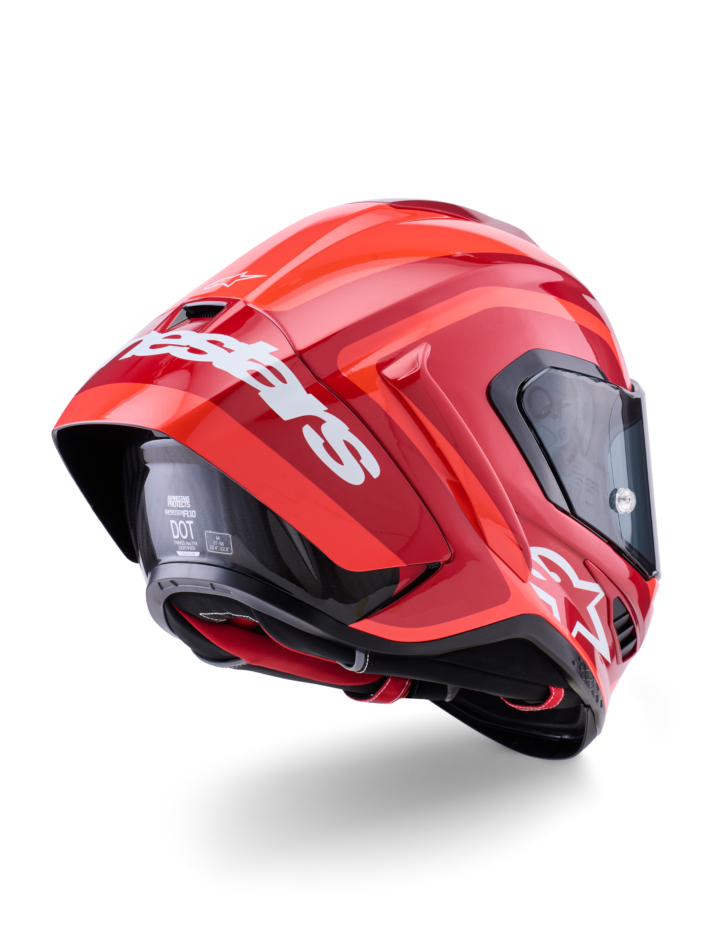 Casco Alpinestars Supertech R10 Arius, rosso lucido con loghi bianchi, vista posteriore a tre quarti che mostra lo spoiler aerodinamico, calotta in fibra di carbonio e profilo racing con visiera scura