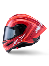 Casco Alpinestars Supertech R10 Arius, casco integrale racing, rosso lucido con grafiche logo bianche, vista laterale di profilo che evidenzia lo spoiler aerodinamico e la visiera trasparente, calotta in composito di fibra di carbonio per il motorsport professionale