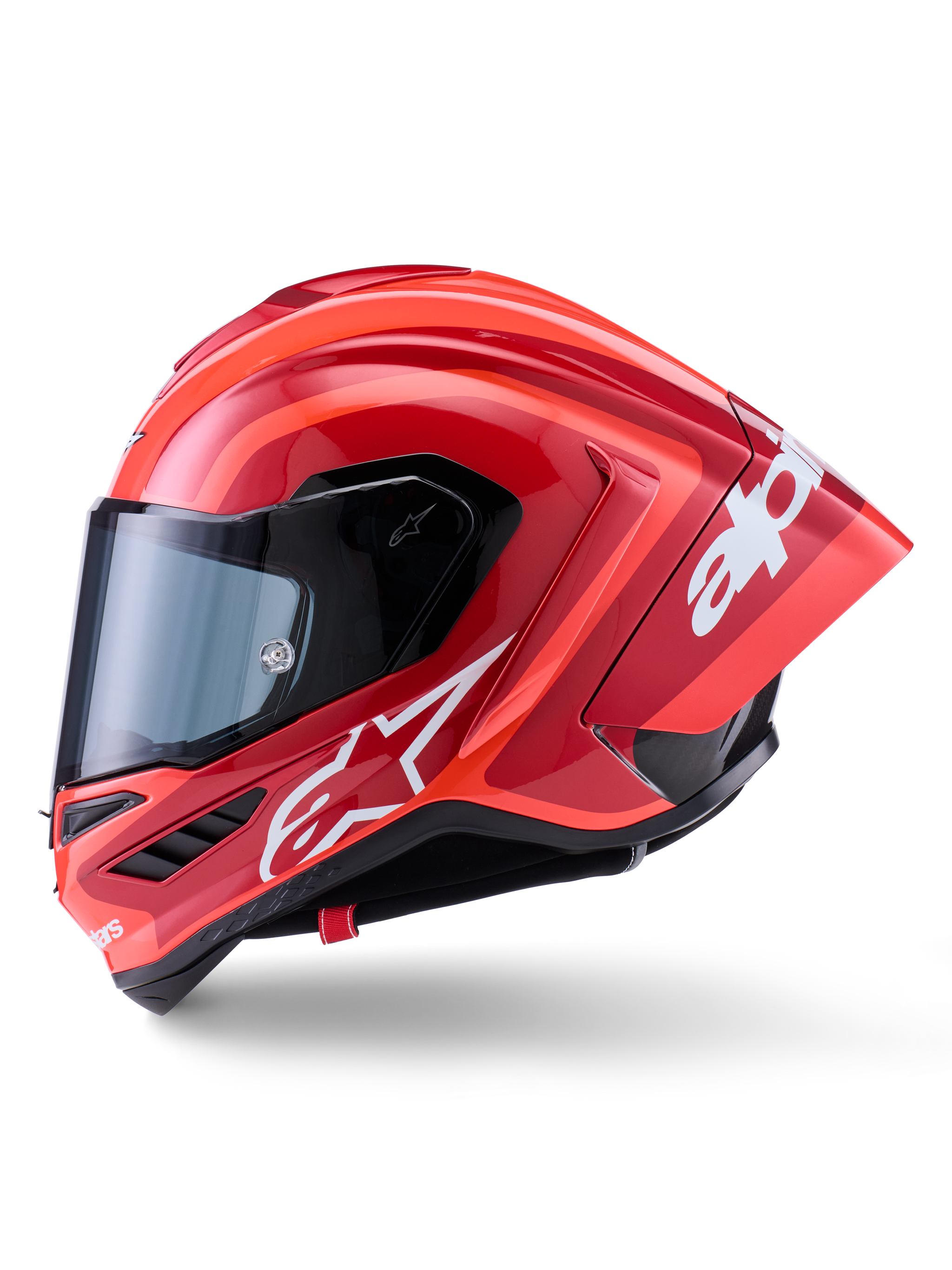 Casco Alpinestars Supertech R10 Arius, casco integrale racing, rosso lucido con grafiche logo bianche, vista laterale di profilo che evidenzia lo spoiler aerodinamico e la visiera trasparente, calotta in composito di fibra di carbonio per il motorsport professionale