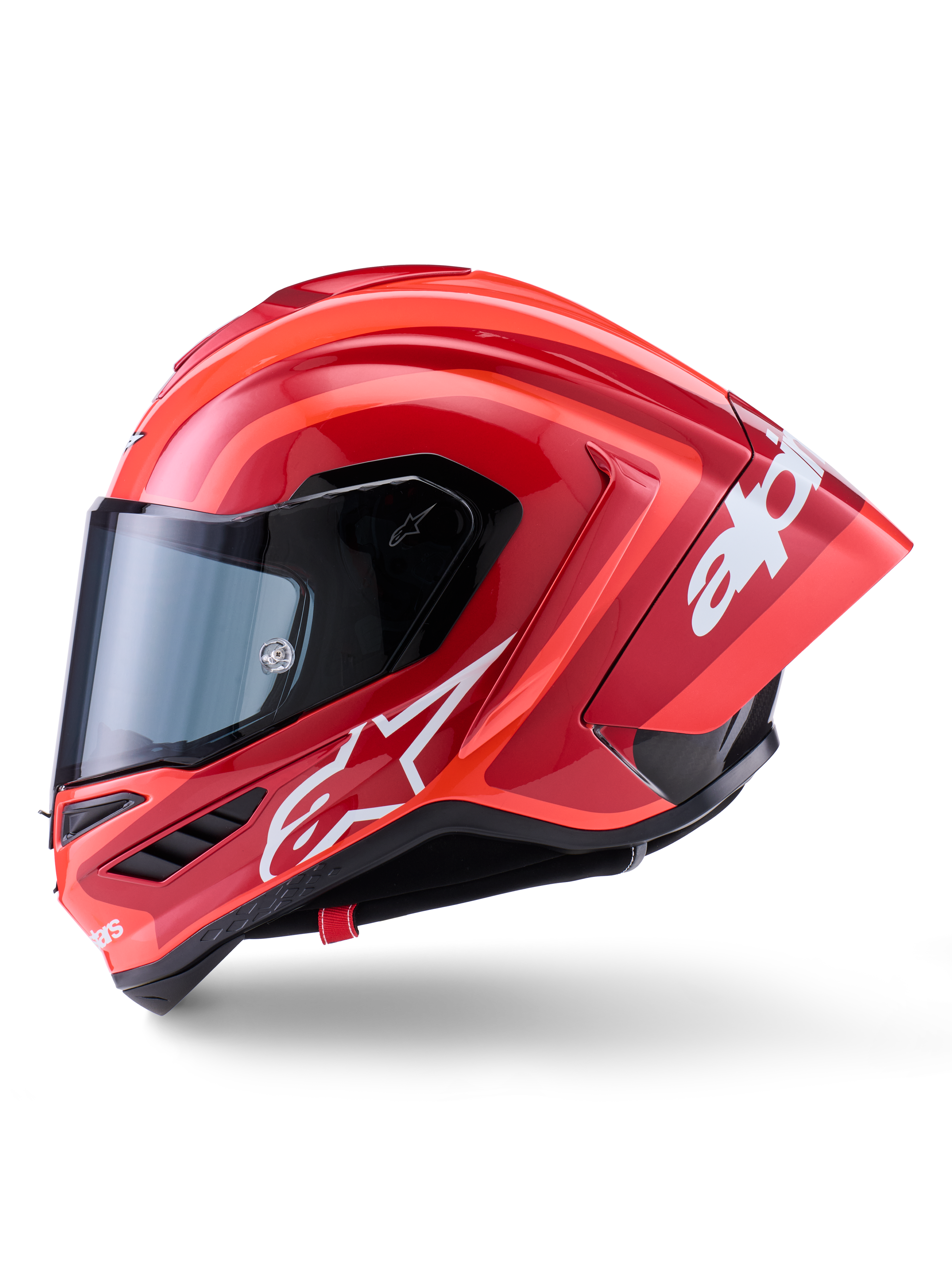 Casco Alpinestars Supertech R10 Arius, casco integrale racing, rosso lucido con grafiche logo bianche, vista laterale di profilo che evidenzia lo spoiler aerodinamico e la visiera trasparente, calotta in composito di fibra di carbonio per il motorsport professionale