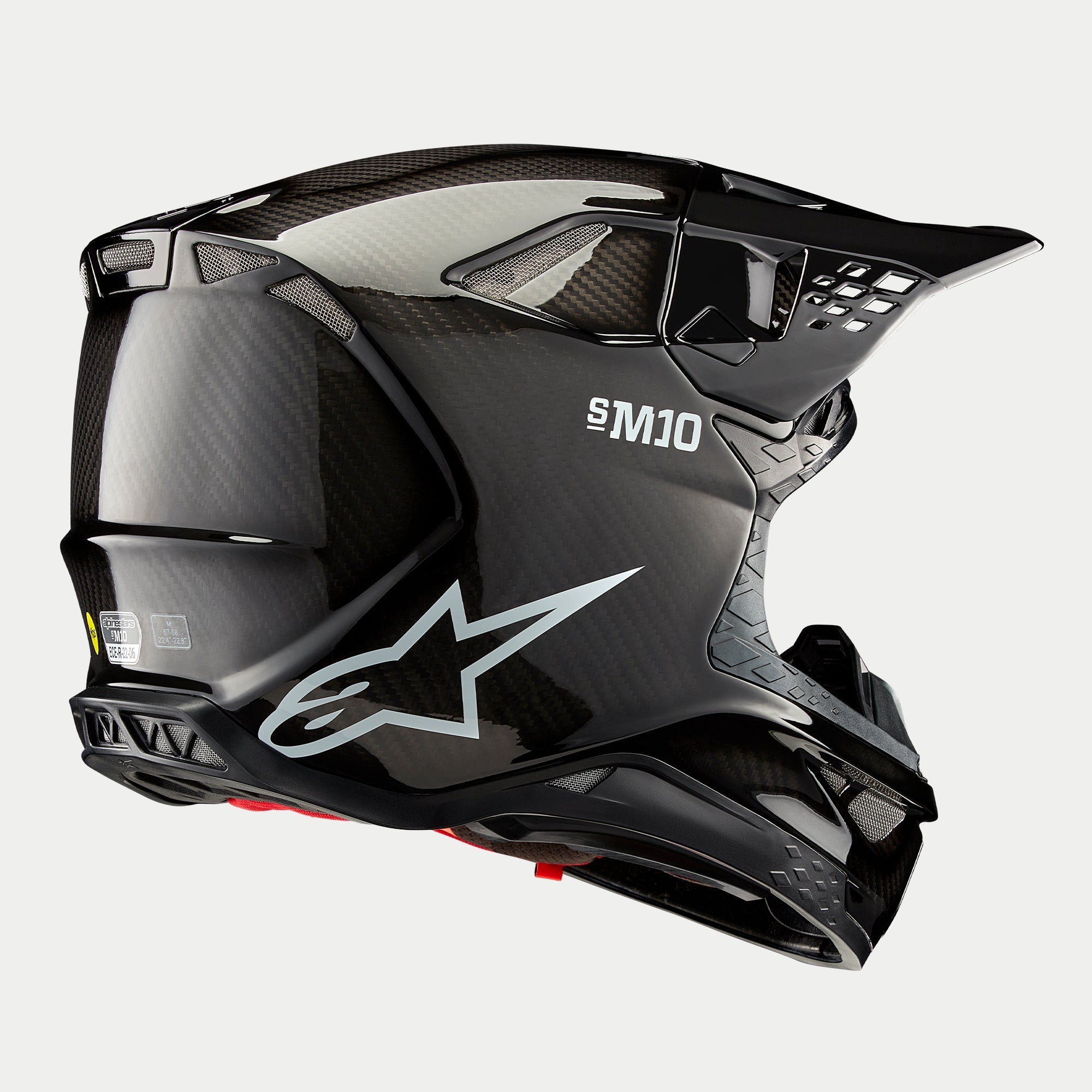 Casco Alpinestars Supertech M10 Solid, casco da motocross, finitura in carbonio nero lucido, con logo Astars bianco e marchio S-M10, calotta aerodinamica con trama in fibra di carbonio a vista e diverse porte di ventilazione