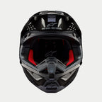 Casco Alpinestars Supertech M10 Solid, casco da motocross, carbonio nero lucido, vista frontale con imbottitura interna rossa, calotta in fibra di carbonio e slogan "ONE GOAL. ONE VISION." sulla zona della visiera