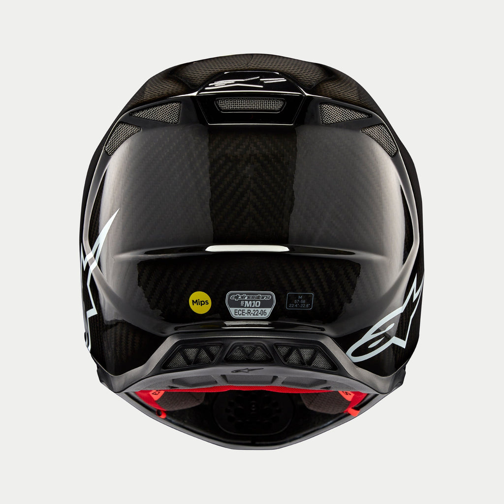 Casco Alpinestars Supertech M10 Solid, Carbonio Nero Lucido, vista posteriore che mostra la trama in fibra di carbonio lucida, logo Alpinestars bianco, adesivi di certificazione MIPS ed ECE, forma aerodinamica con porte di ventilazione