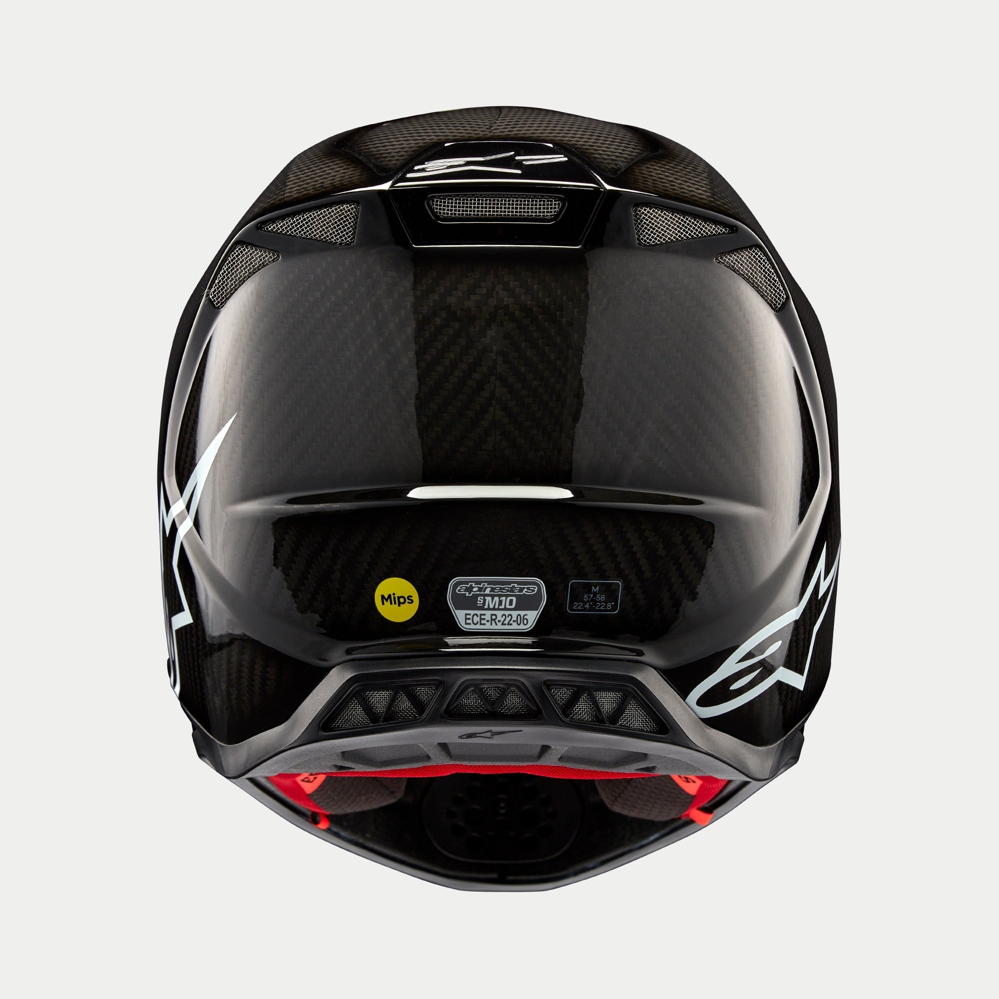 Casco Alpinestars Supertech M10 Solid, Carbonio Nero Lucido, vista posteriore che mostra la trama in fibra di carbonio lucida, logo Alpinestars bianco, adesivi di certificazione MIPS ed ECE, forma aerodinamica con porte di ventilazione