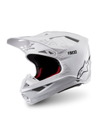 Alpinestars Casco Supertech M10 Solid ECE 22.06, casco da motocross bianco lucido con imbottitura interna nera e rossa, visiera parasole e prese d’aria multiple, vista a tre quarti