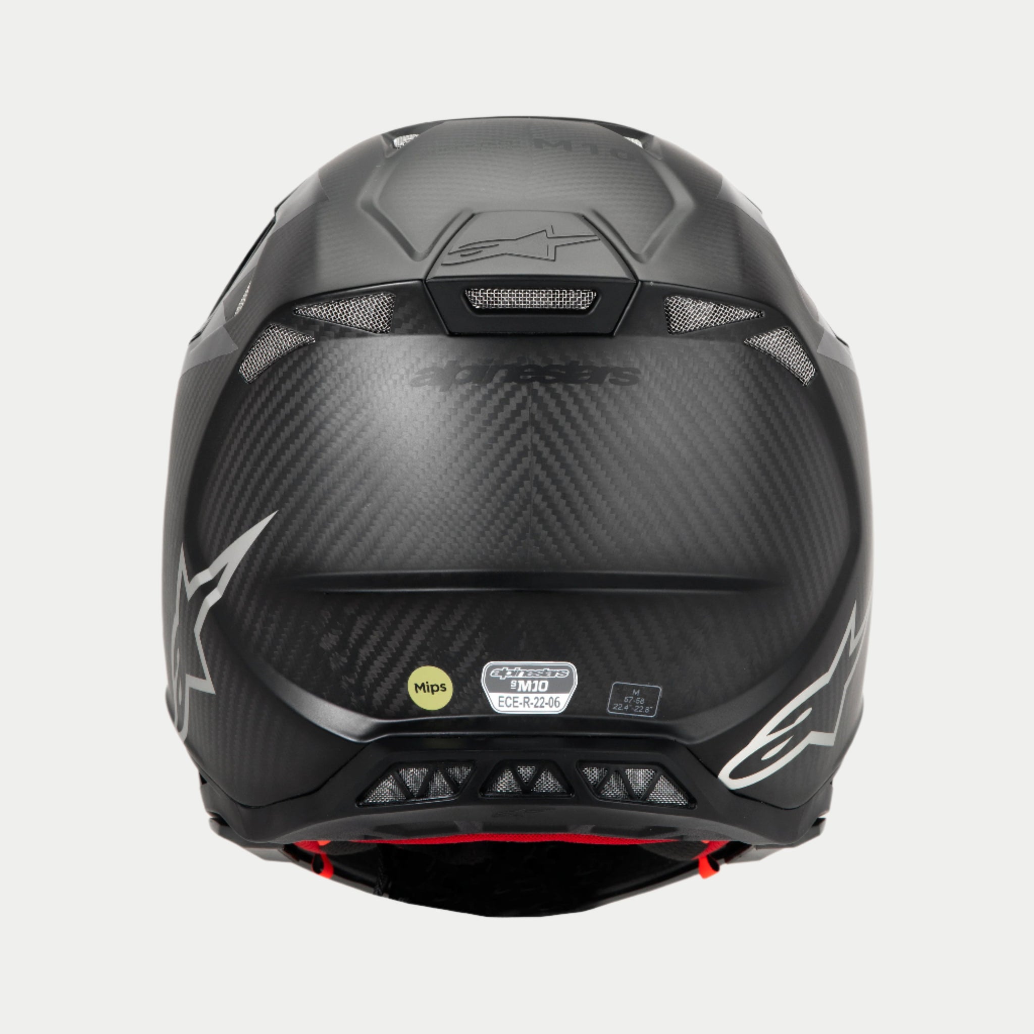 Casco Alpinestars Supertech M10 Fame ECE 22.06, vista posteriore, Nero Carbonio Opaco e Lucido, con trama in fibra di carbonio a vista, prese d'aria in rete, etichette di certificazione MIPS ed ECE e logo Alpinestars.