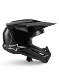 Alpinestars S-M3 Solid Helmet, casco da motocross, nero lucido, vista laterale con logo a stella bianca, design aerodinamico angolare con prese d'aria in mesh e visiera, equipaggiamento protettivo per il fuoristrada
