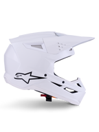 Casco Alpinestars S-M3 Solid, casco da motocross, bianco lucido, vista di profilo laterale con logo a stella nero, calotta aerodinamica angolare, prese d'aria multiple, visiera e mentoniera integrate, protezione per competizioni fuoristrada