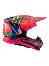 Alpinestars Supertech M10 Deegan Monster Helmet, casco da motocross, arancione fluo, viola e rosa lucido, vista laterale con marchio Monster Energy, calotta aerodinamica in carbonio con prese d'aria multiple, protezione professionale per gare fuoristrada
