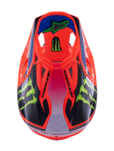 Alpinestars Supertech M10 Deegan Monster Helmet, casco da motocross, arancione fluo con sfumatura viola e rosa, con loghi Monster Energy verdi e grafiche nere, vista dall'alto che mostra il profilo aerodinamico e le prese d'aria