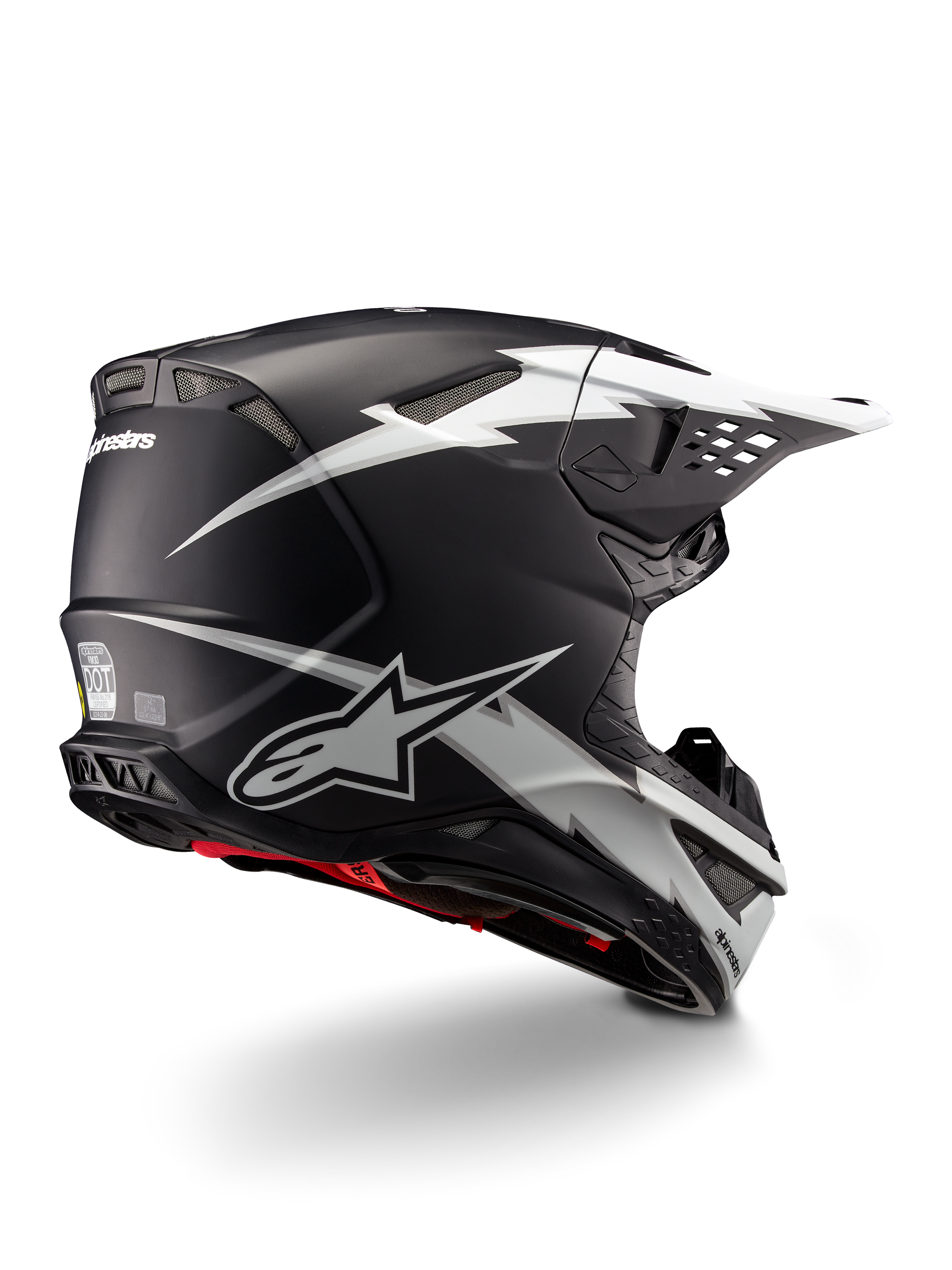 Casco Alpinestars Supertech M10 Ampress, casco da motocross, nero e bianco opaco, con grafiche a fulmini bianchi su calotta nera opaca, vista posteriore a tre quarti che mostra il logo Alpinestars e le prese d'aria