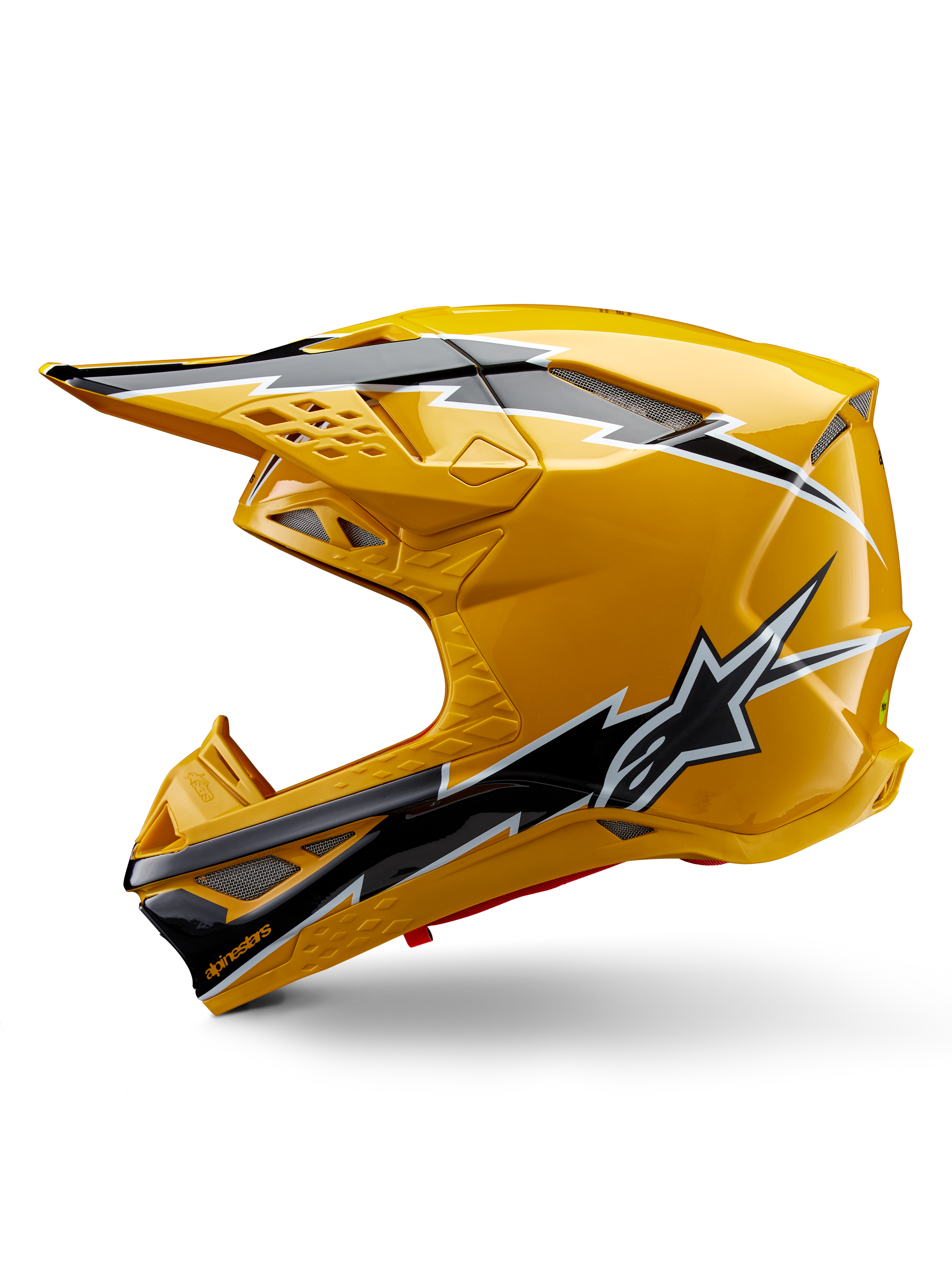 Casco Alpinestars Supertech M10 Ampress, casco da motocross, giallo lucido con grafiche nere e bianche, vista laterale con design angolari audaci, logo a stella Alpinestars e molteplici prese d'aria con rete argentata, attrezzatura professionale per corse fuoristrada
