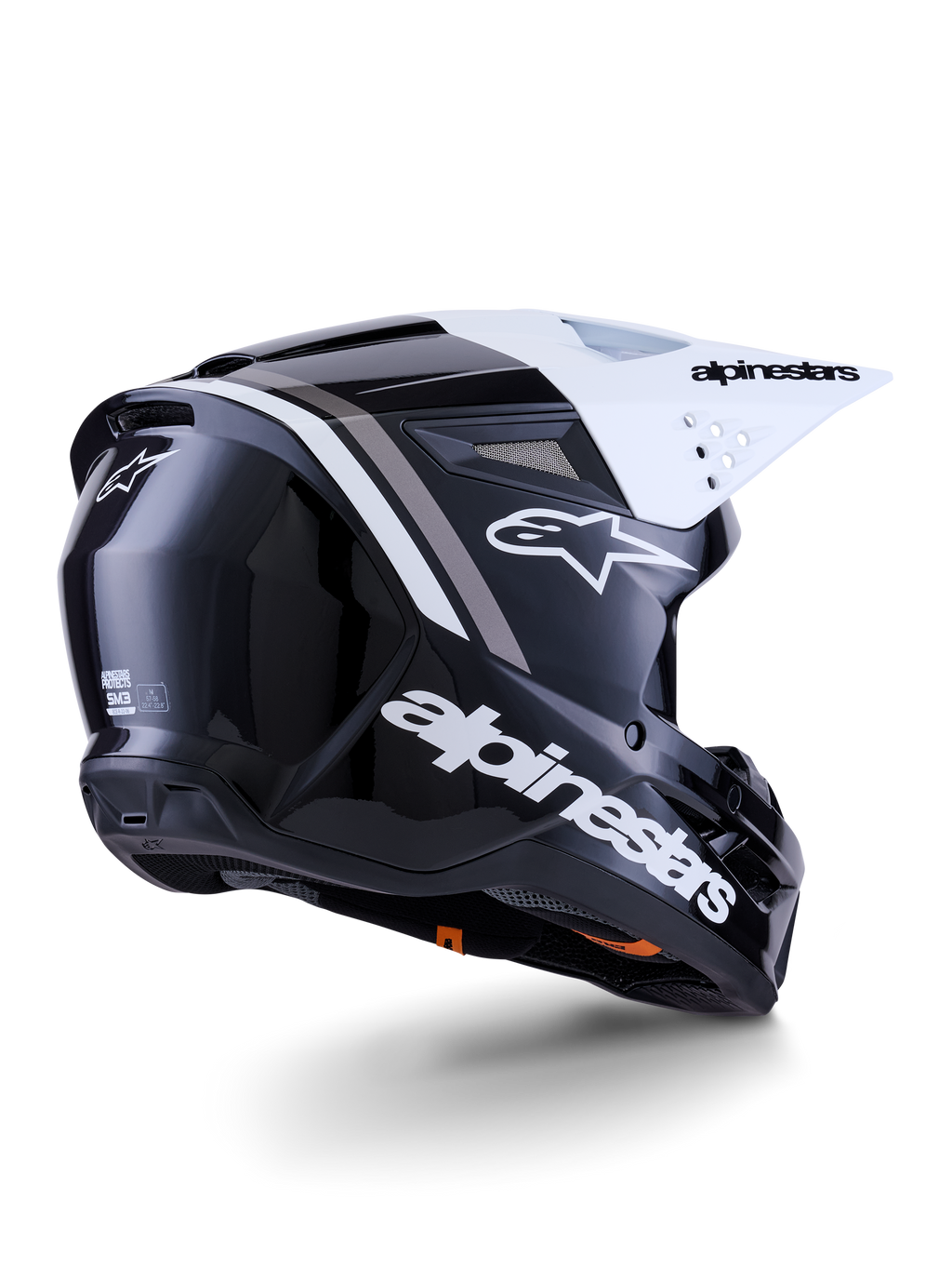 Casco Alpinestars S-M3 Radium, casco da motocross, nero, bianco e grigio lucido, vista posteriore-laterale con visiera bianca, con logo Alpinestars sul lato e sul retro, calotta aerodinamica con rete di ventilazione, progettato per motocross fuoristrada ed enduro