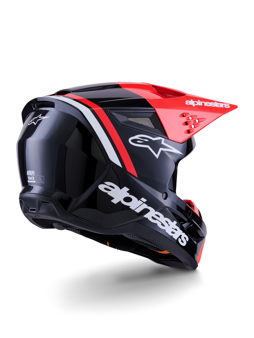 Casco Alpinestars S-M3 Radium, casco da motocross, nero, rosso fluo e bianco lucido, vista posteriore a tre quarti che mostra il design aerodinamico, loghi bianchi e visiera rosso brillante, protezione per la testa fuoristrada ad alte prestazioni