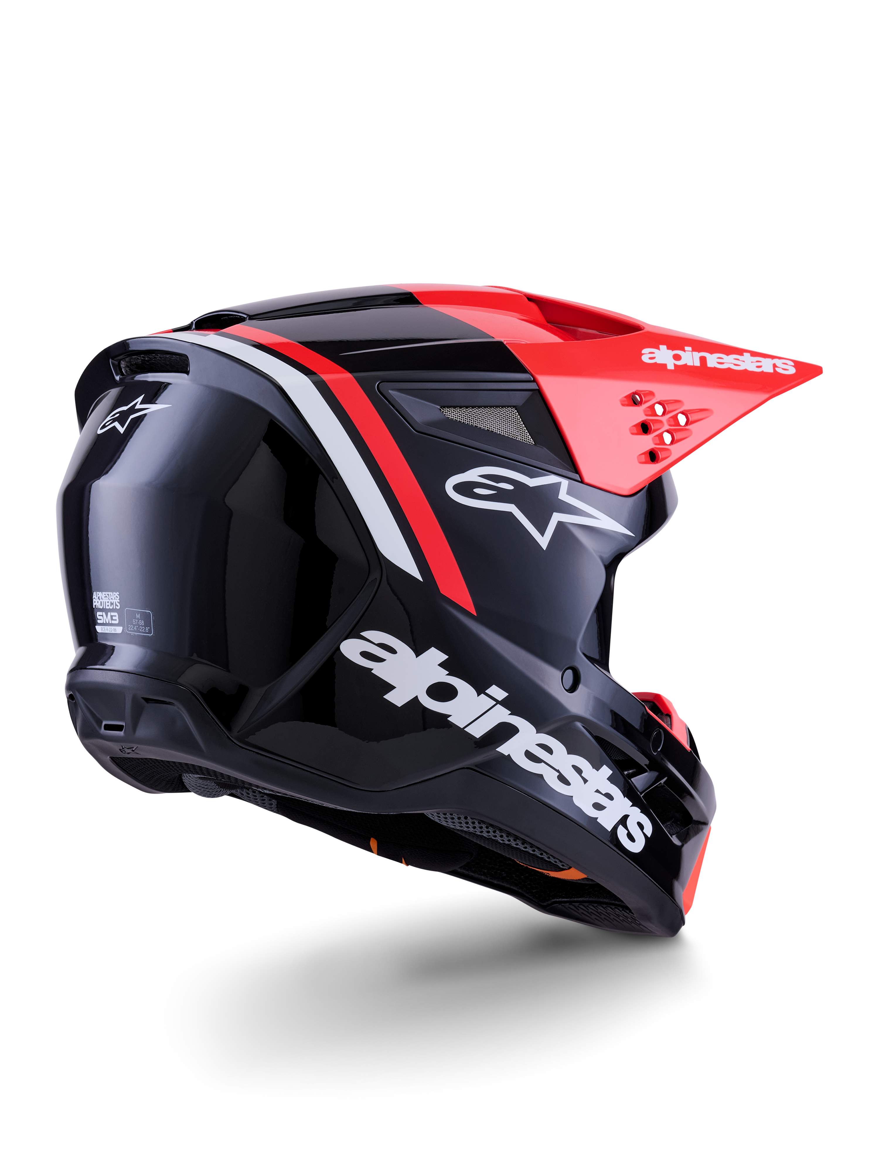 Casco Alpinestars S-M3 Radium, casco da motocross, nero, rosso fluo e bianco lucido, vista posteriore a tre quarti che mostra il design aerodinamico, loghi bianchi e visiera rosso brillante, protezione per la testa fuoristrada ad alte prestazioni