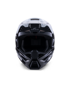 Casco Alpinestars S-M3 Radium, casco da motocross, nero, bianco e grigio lucido, vista frontale, caratterizzato da un design della calotta aggressivo con visiera bianca, mentoniera nera e prese di ventilazione con rivestimento in mesh.