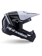 Casco Alpinestars S-M3 Radium, casco da motocross off-road, nero, bianco e grigio lucido, design aerodinamico angolare con prese d'aria, vista laterale, finitura lucida con strisce grigie e visiera bianca con logo Alpinestars