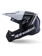 Casco Alpinestars S-M3 Radium ECE 22.06, vista laterale, finitura lucida nera e bianca, strisce racing grigie, logo Alpinestars bianco sul lato e sulla zona del mento, design ventilato per motocross ed enduro