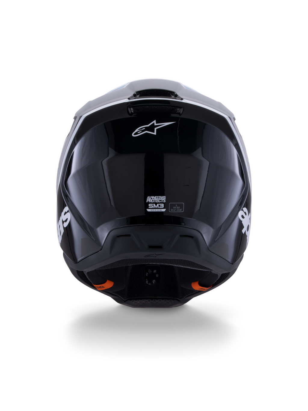 Casco Alpinestars S-M3 Radium ECE 22.06, casco da motocross, nero bianco grigio lucido, vista posteriore che mostra la finitura nera lucida, logo Alpinestars a stella, porte di scarico della ventilazione ed etichetta di certificazione ECE.