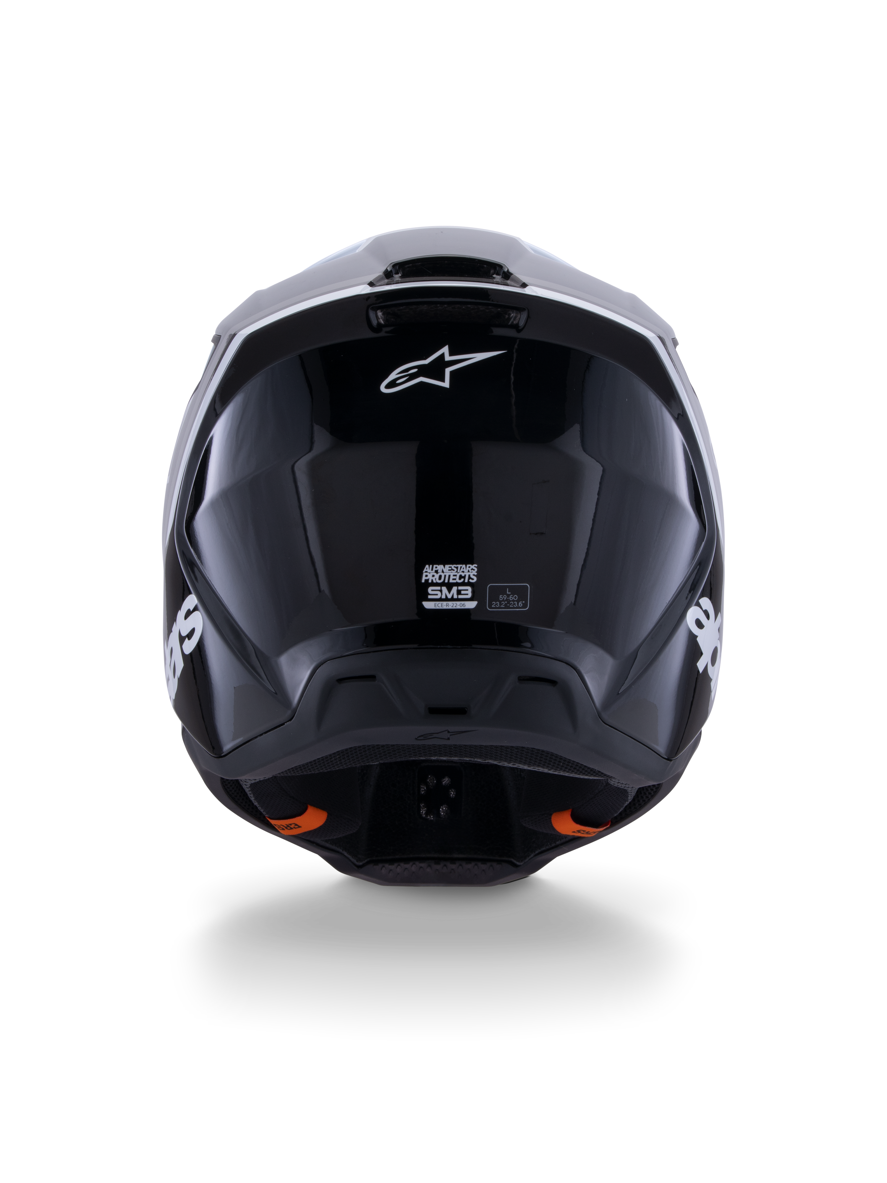 Casco Alpinestars S-M3 Radium ECE 22.06, casco da motocross, nero bianco grigio lucido, vista posteriore che mostra la finitura nera lucida, logo Alpinestars a stella, porte di scarico della ventilazione ed etichetta di certificazione ECE.