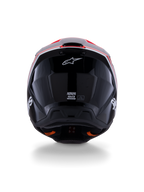 Alpinestars S-M3 Radium Helmet ECE 22.06, casco da motocross, nero lucido con accenti rosso fluo e bianchi, vista posteriore che mostra il design aerodinamico della calotta, logo a stella bianco ed etichette di certificazione.
