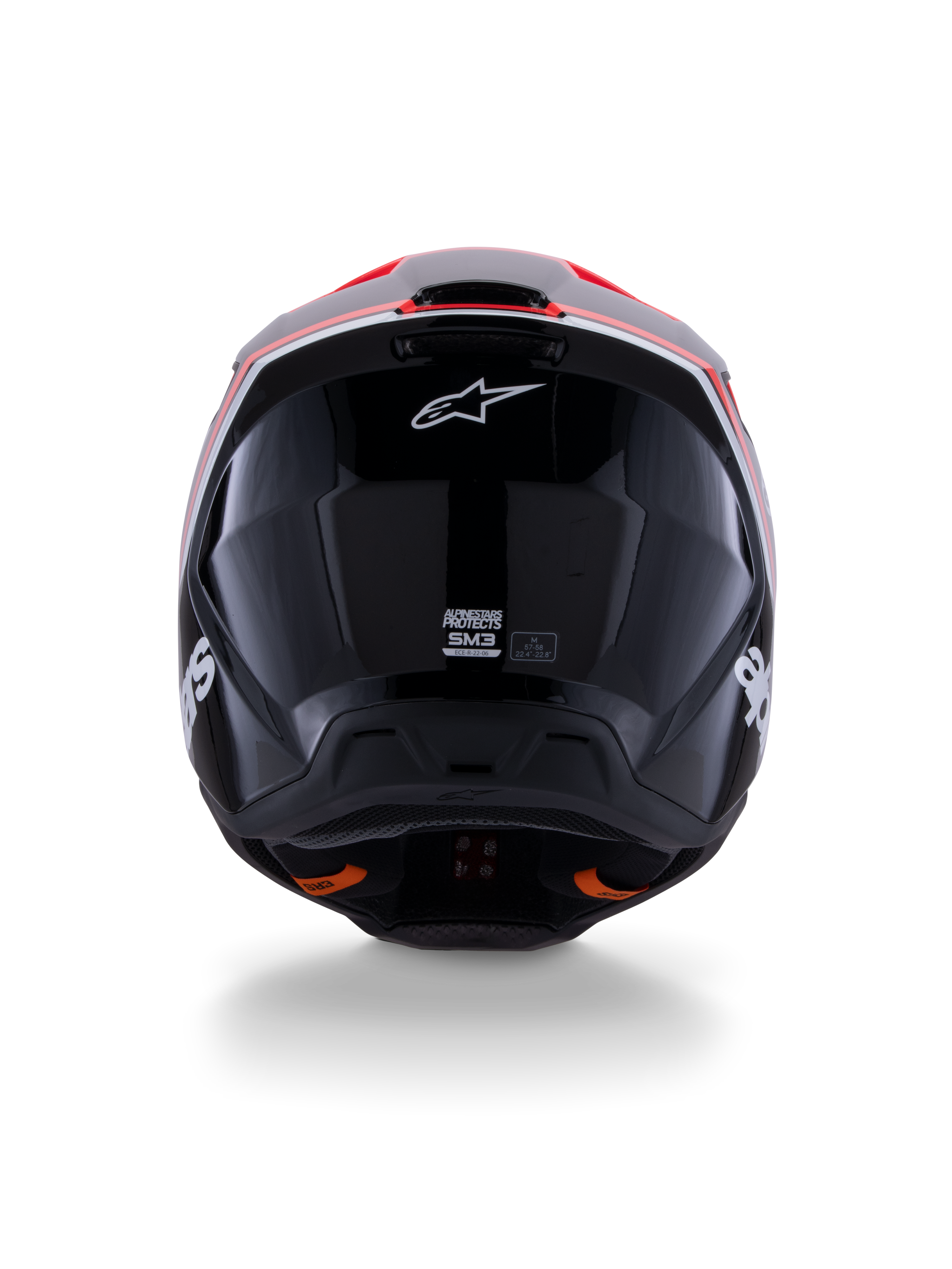 Alpinestars S-M3 Radium Helmet ECE 22.06, casco da motocross, nero lucido con accenti rosso fluo e bianchi, vista posteriore che mostra il design aerodinamico della calotta, logo a stella bianco ed etichette di certificazione.
