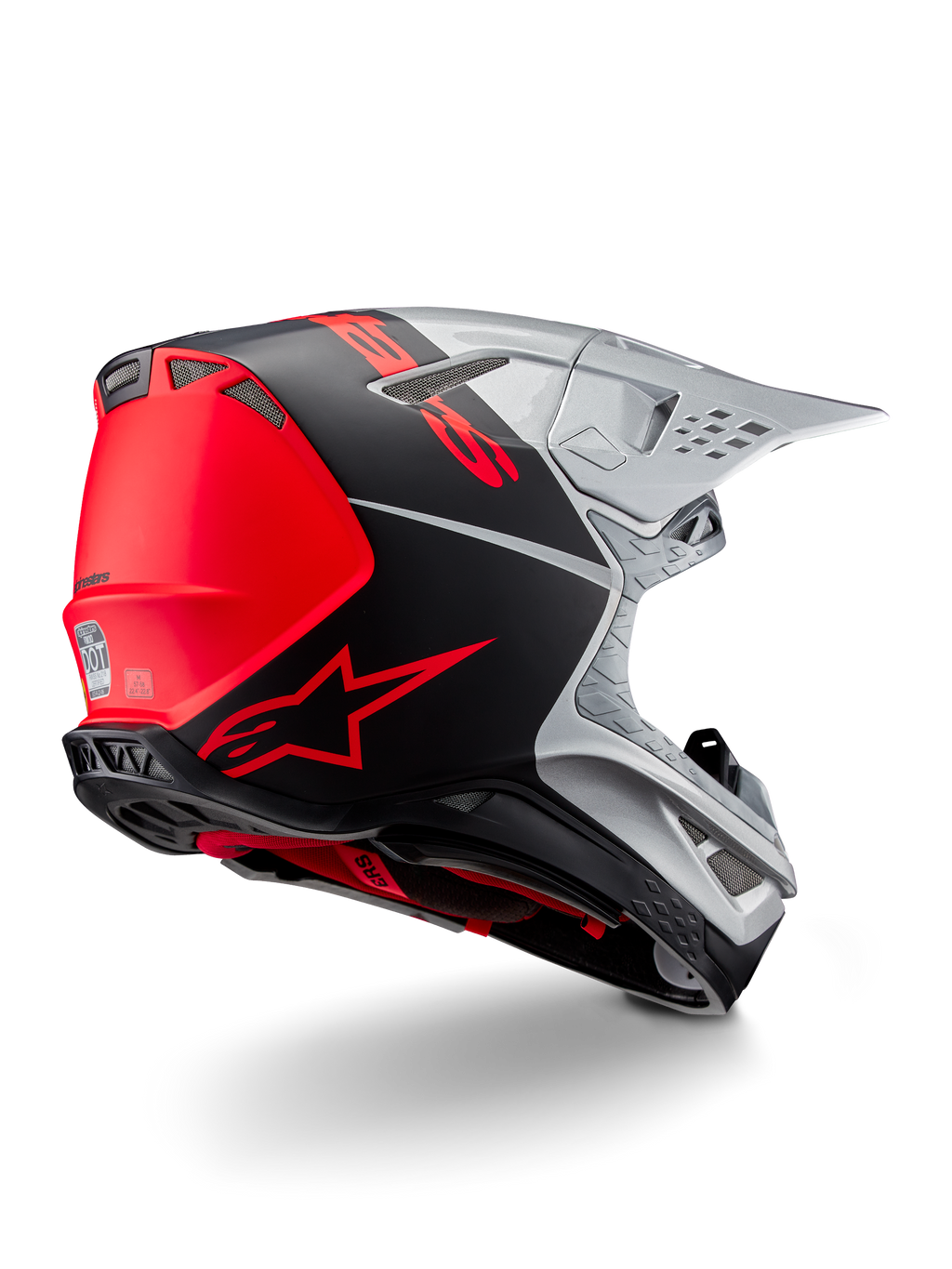 Casco Alpinestars Supertech M10 Flood ECE 22.06, casco da motocross, argento, nero e arancione fluo, vista laterale posteriore che evidenzia il design aerodinamico della calotta, le prese di ventilazione e la finitura opaca-lucida