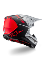 Casco Alpinestars Supertech M10 Flood ECE 22.06, casco da motocross, argento, nero e arancione fluo, vista laterale posteriore che evidenzia il design aerodinamico della calotta, le prese di ventilazione e la finitura opaca-lucida