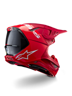 Casco Alpinestars Supertech M10 Flood, casco da motocross, rosso e rosso fluo, finitura opaca e lucida, vista di profilo posteriore con logo Alpinestars bianco e accenti in fibra di carbonio, design aerodinamico con molteplici prese d'aria, protezione per la testa off-road ad alte prestazioni