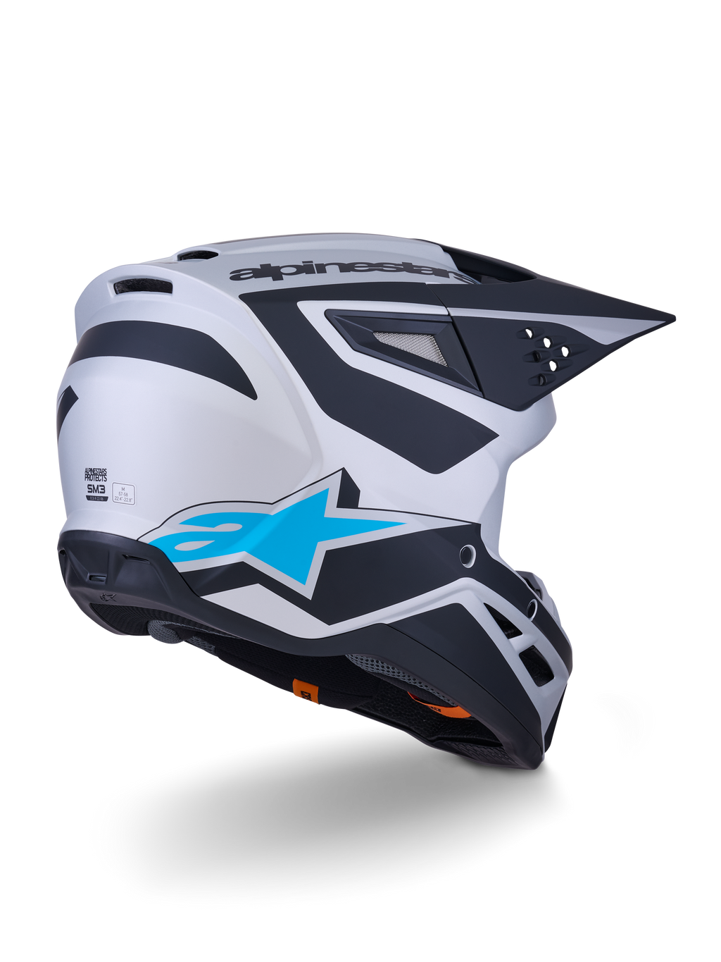 Alpinestars S-M3 Heat Helmet ECE 22.06, casco da motocross, argento, blu e nero opaco, vista posteriore con grande logo a stella blu e motivi angolari neri, calotta aerodinamica con porte di ventilazione, protezione per corse off-road ad alte prestazioni