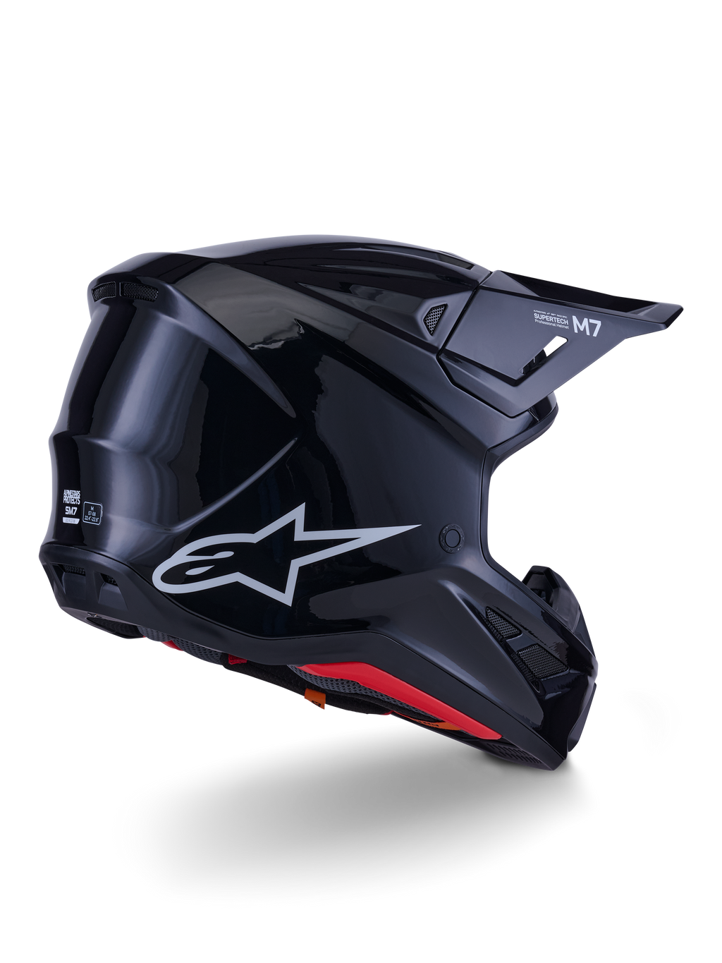 Casco Alpinestars S-M7 Solid, casco da motocross, nero lucido, caratterizzato da una calotta aerodinamica con logo Astars argento, finiture interne rosse e porte di ventilazione integrate, progettato per la protezione nelle corse fuoristrada