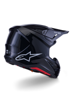 Casco Alpinestars S-M7 Solid, casco da motocross, nero lucido, caratterizzato da una calotta aerodinamica con logo Astars argento, finiture interne rosse e porte di ventilazione integrate, progettato per la protezione nelle corse fuoristrada